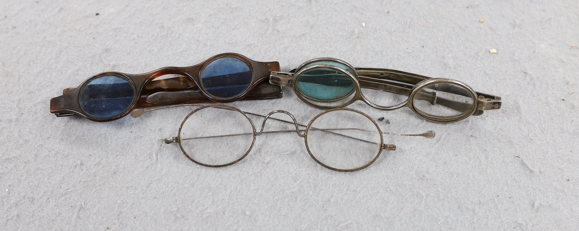 A pair of George IV silver mounted spectacles, with four lenses, (two folding and one missing), Joseph Wilmore, Birmingham, 1825? and tow other pairs of spectacles.